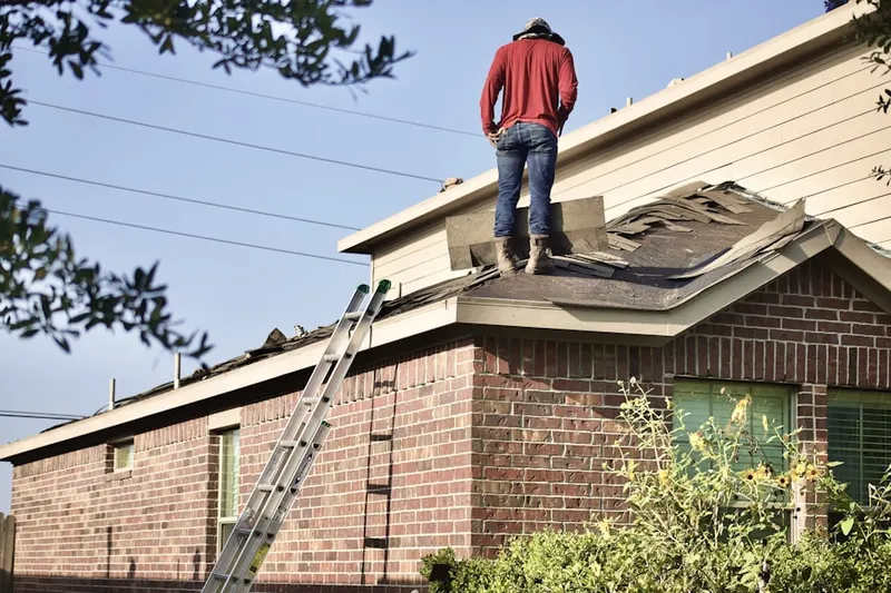 Professional roofer working on a residential roof in Madisonburg